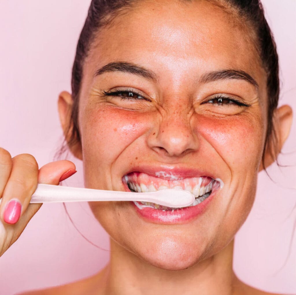 Euthymol Image Woman brushing teeth with white toothbrush